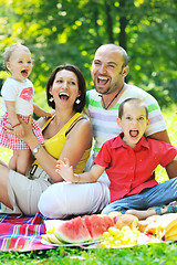 Image showing happy young couple with their children have fun at park