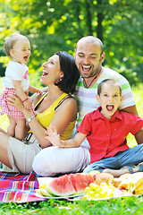 Image showing happy young couple with their children have fun at park