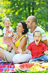 Image showing happy young couple with their children have fun at park