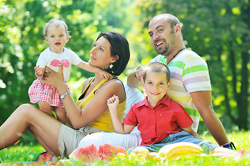 Image showing happy young couple with their children have fun at park