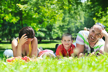 Image showing happy young couple with their children have fun at park