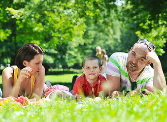 Image showing happy young couple with their children have fun at park