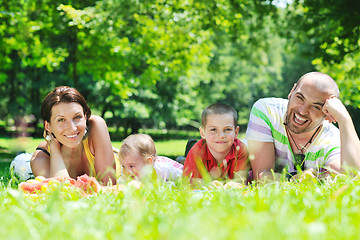 Image showing happy young couple with their children have fun at park