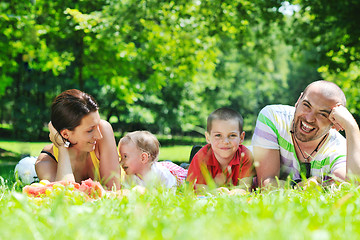 Image showing happy young couple with their children have fun at park