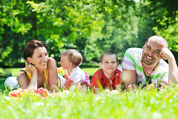 Image showing happy young couple with their children have fun at park