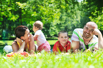 Image showing happy young couple with their children have fun at park