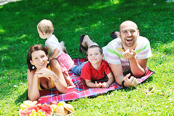 Image showing happy young couple with their children have fun at park