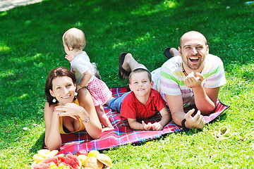 Image showing happy young couple with their children have fun at park