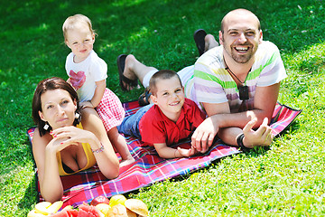 Image showing happy young couple with their children have fun at park