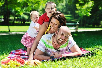 Image showing happy young couple with their children have fun at park