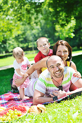 Image showing happy young couple with their children have fun at park