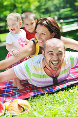 Image showing happy young couple with their children have fun at park