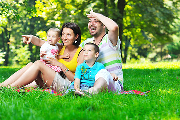 Image showing happy young couple with their children have fun at park