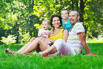 Image showing happy young couple with their children have fun at park