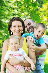 Image showing happy young couple with their children have fun at park