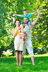 Image showing happy young couple with their children have fun at park