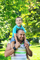 Image showing happy father and son have fun at park