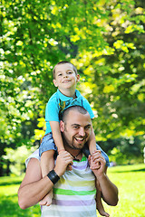 Image showing happy father and son have fun at park