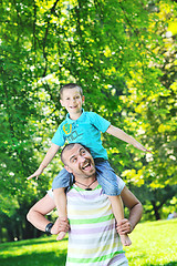 Image showing happy father and son have fun at park