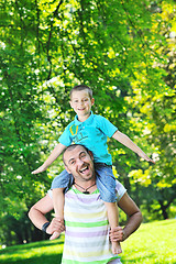 Image showing happy father and son have fun at park