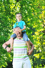 Image showing happy father and son have fun at park