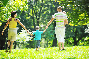 Image showing happy young couple with their children have fun at park