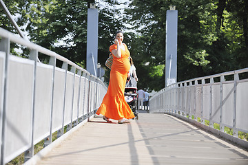 Image showing happy pregnant woman talking by cellphone