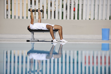 Image showing young man exercise at poolside