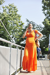 Image showing happy pregnant woman talking by cellphone