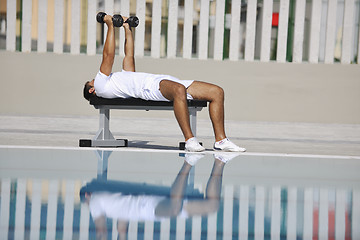 Image showing young man exercise at poolside
