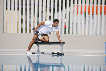 Image showing young man exercise at poolside