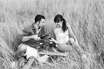 Image showing happy couple enjoying countryside picnic in long grass