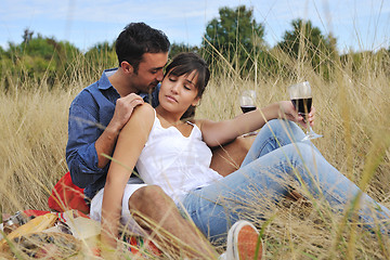 Image showing happy couple enjoying countryside picnic in long grass