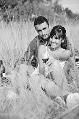 Image showing happy couple enjoying countryside picnic in long grass