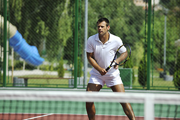 Image showing young man play tennis outdoor