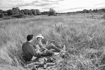 Image showing happy couple enjoying countryside picnic in long grass