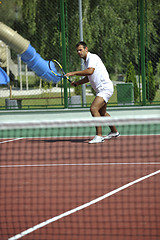 Image showing young man play tennis outdoor