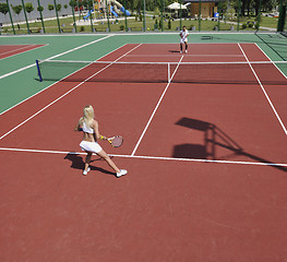 Image showing young woman play tennis game outdoor