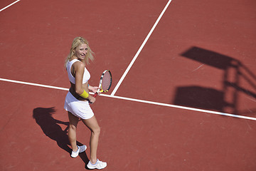 Image showing young woman play tennis game outdoor