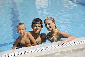 Image showing happy young family have fun on swimming pool