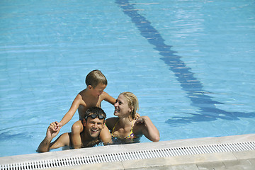 Image showing happy young family have fun on swimming pool