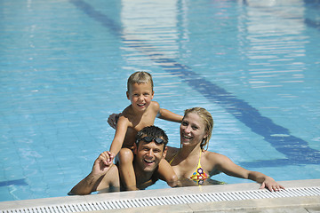 Image showing happy young family have fun on swimming pool