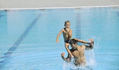 Image showing happy father and son at swimming pool