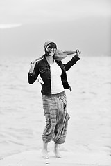 Image showing beautiful young woman on beach with scarf