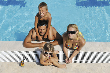 Image showing happy young family have fun on swimming pool