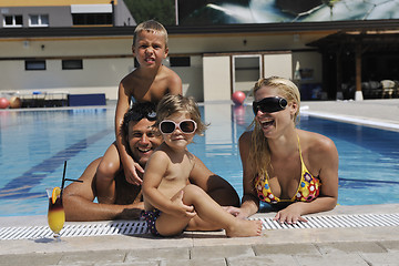 Image showing happy young family have fun on swimming pool