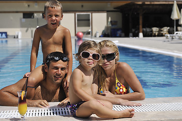 Image showing happy young family have fun on swimming pool