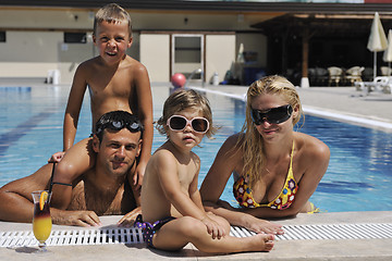 Image showing happy young family have fun on swimming pool