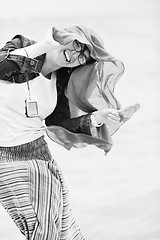 Image showing beautiful young woman on beach with scarf