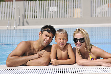 Image showing happy young family have fun on swimming pool